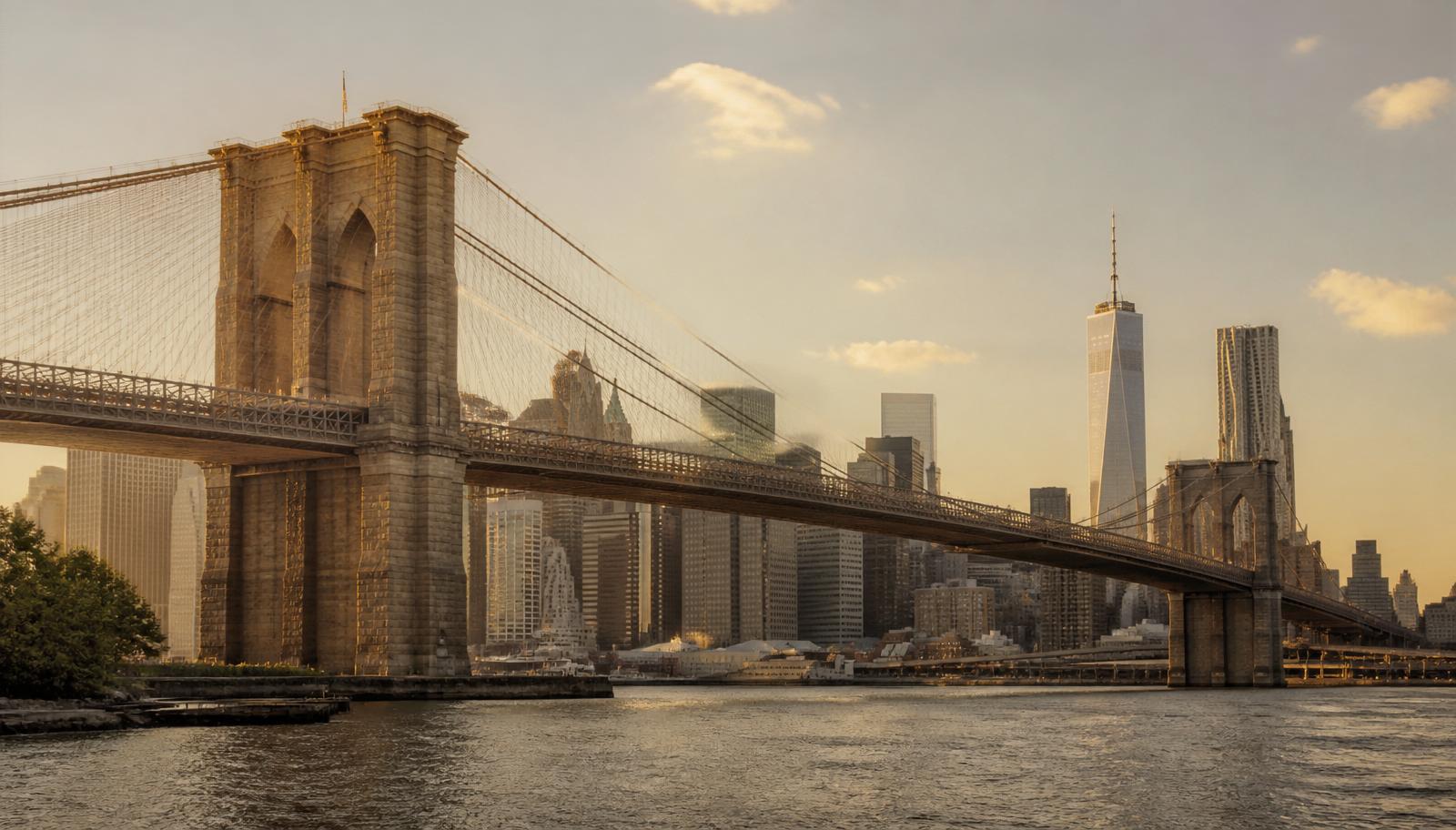 Brooklyn Bridge over the East River at golden hour with the Lower Manhattan skyline
