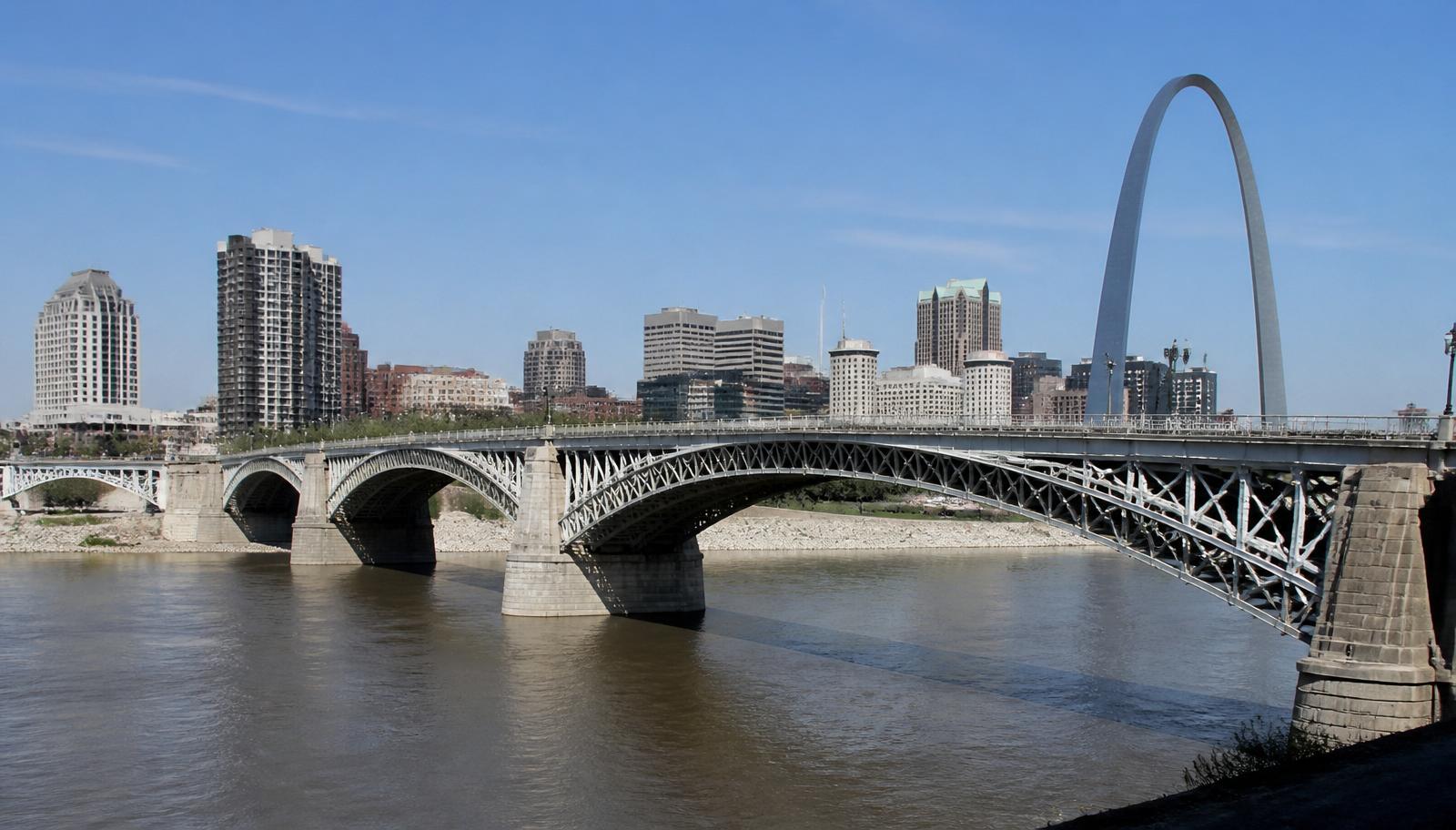 Eads Bridge steel deck arches over the Mississippi River in St. Louis with the Gateway Arch in the background